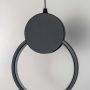 Closeup of black circular LED pendant lamp highlighting sleek ring design and contemporary minimalist style.