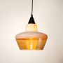 Stylish pendant light with white and amber glass shade illuminated on white background for dining and living room use.