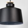 A closeup view of the black pendant lamp focusing on the upper section showing the smooth matte black finish and the refined detailing that enhances its modern look.
