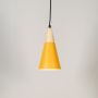 Yellow pendant light with natural wood top and matte finish shade displayed on plain white background.