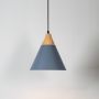 Grey pendant light with wood accent illuminated on white background for stylish home and kitchen ceiling lighting.