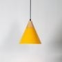 Yellow pendant ceiling light with wood accent illuminated on white background for stylish home and dining room lighting.