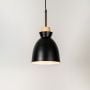 Black pendant ceiling light with wood top illuminated on white background for stylish home dining and living room lighting.