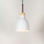 White pendant ceiling light with wood top illuminated on white background for stylish kitchen dining and living room lighting.