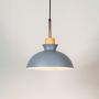 Grey dome pendant ceiling light with wood top illuminated on white background for stylish dining and kitchen interior lighting.