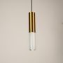 White and gold marble and metal cylinder pendant light hanging against plain background with light off for clean elegant décor.