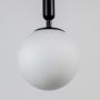 A closeup view of the pendant light showing the frosted globe surface and the smooth matte black cylindrical top capturing fine material details.