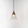 Glass pendant light with bulb on white background featuring metal fitting for modern interior lighting decor.