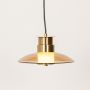 Amber glass pendant light with gold metal top shown with lights on against a white background highlighting its warm modern glow.