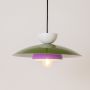 Multicolor metal pendant light glowing softly on white background for stylish kitchen dining and living room decor.