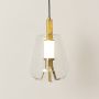 A modern glass pendant with warm illumination showcased on a white background emphasizing its sleek gold fittings and clear angular glass shade with lights on.