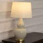 Frahm Ceramic Table Lamp with White Shade Light On White Background