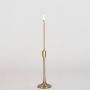 Brushed gold candle holder with tall design shown in natural room setting without white background for styled look