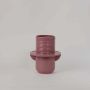 Contemporary pink ceramic vase with wide base and vertical grooves adding modern charm to home interiors.