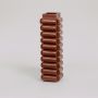 Brown ceramic tall decorative vase with geometric ribbed design for modern table and home decor.