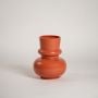 Terracotta orange decorative vase on a bright white background showcasing its bold modern silhouette for contemporary home styling.