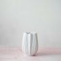 White textured vase showcased on a clean white background with soft lighting for minimalist appeal.