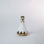 White and gold ceramic vase with triangular geometric design displayed against a clean white background.