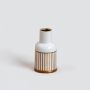 A stylish white ceramic vase with refined gold striping captured on a bright background highlighting its smooth finish and modern aesthetic appeal.