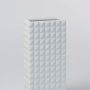 Closeup view of the white textured ceramic vase highlighting its geometric pattern and smooth matte finish for elegant modern styling.