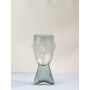 Handcrafted glass vase face shaped in transparent finish artistic modern accent decor light on white background for stylish home.