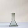 Smoky grey glass vase in triangular shape shown on plain white background for modern decorative placement.