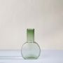 Elegant green glass vase with round geometric design displayed against clean white background for decorative use.