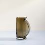 Smoky half moon glass vase with ribbed texture displayed on clean white background for modern decorative styling.