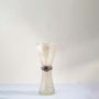 Decorative golden speckled hourglass glass vase displayed against white background highlighting modern design style.