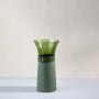 Modern tall green glass vase in wide mouth design displayed against white background for stylish home decoration.
