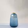 Blue glass vase with scallop textured finish and metallic rim displayed on clean white background modern decor glass vase.