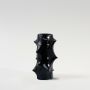 Black sculptural ceramic vase with glossy finish displayed on a clean white background for product showcase.