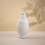 Artistic white ceramic vase with detailed handcrafted finish shown on white background perfect for living room and tabletop styling.