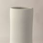 Closeup view of white ceramic vase showing raised textured pattern and matte finish ideal for modern tabletop styling.