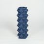 Blue ceramic geometric floor vase with faceted diamond texture isolated on clean white background for modern decor styling.