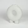 White ceramic donut vase with textured surface and round hollow center isolated on clean white background for modern decor styling.
