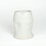 White ceramic sculpted vase with embossed floral band isolated on white background for elegant tabletop decor placement.