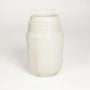 White ceramic textured decorative vase with detailed surface pattern isolated on clean white background for contemporary home decor use.