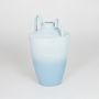 Light blue decorative ceramic flower vase isolated on white background modern sculpted vase for home decor styling.