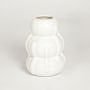 White ceramic decorative vase with sculpted tiered design perfect for modern living room console table or shelf decor styling.
