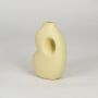 Yellow ceramic decorative vase with modern design flower vase for tabletop shelf console living room decor styling.