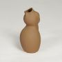 Brown ceramic sculpted vase with smooth matte finish isolated on clean white background for modern home decor styling.