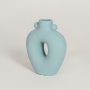 Light blue ceramic decorative vase with sculptural hollow design perfect for modern living room console table decor styling.