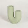 Tuba textured light green ceramic U shaped vase isolated on clean white background for modern home decor styling.