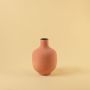 Terracotta modern metal vase displayed on a clean white background highlighting its textured finish and sculptural shape.