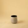 Small cream decorative pot with black interior displayed on a clean white background for simple minimal home styling.