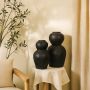 Black textured decorative vase placed in a curated interior setting enhancing shelves consoles and living spaces with artistic modern decor.