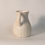 Double handle vase displayed on a plain white background highlighting handmade ribbed texture and vintage-inspired form.