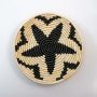 Handwoven basket wall plate on plain white background showing natural weaving texture.