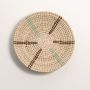 Natural rattan woven wall basket with turquoise and black detailing on a white background for elegant interior styling.
